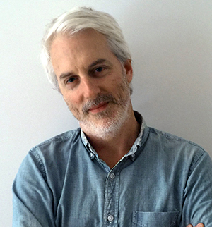 Headshot of Bradley Horn, head slightly tilted to the left, smiling at the camera.