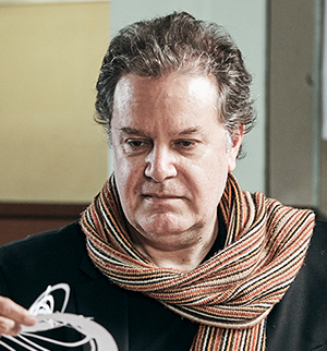 Headshot of Fabian Llonch, looking down.