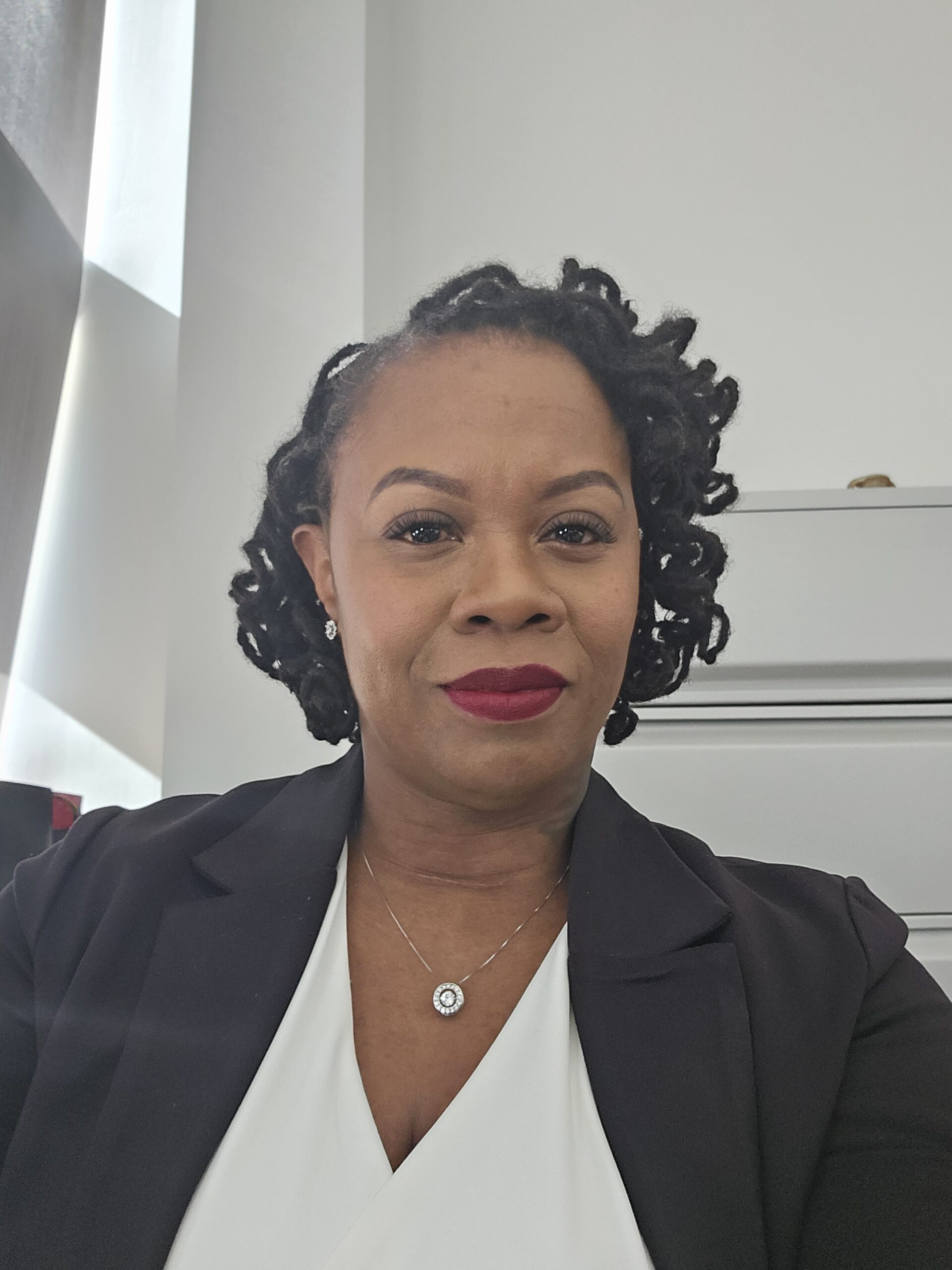 Headshot of Nicole Smith, smiling at the camera.