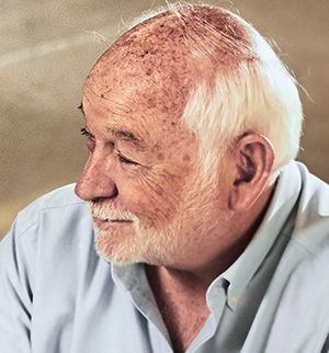 Headshot of Leonard Hopper, looking to the left and smiling.