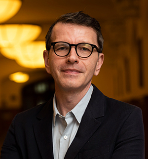 Headshot of Sean Weiss, smiling at the camera.