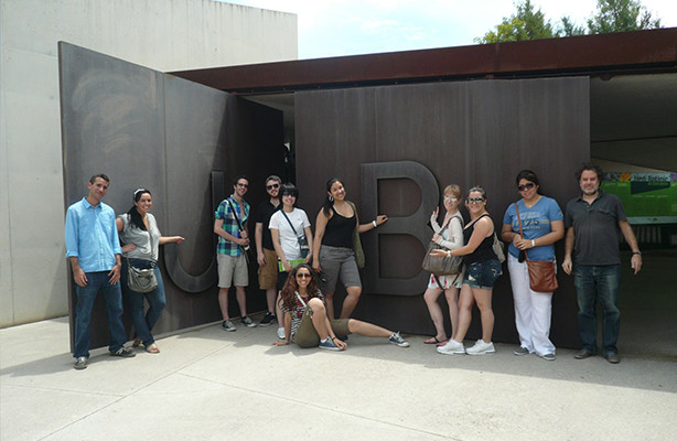 Eleven MArch I students standing in front of an architectural building.