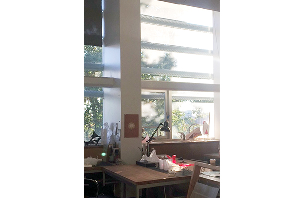 An interior view of the studio at the cost-effective Spitzer School of Architecture, showcasing the shading device on the facade of the building.