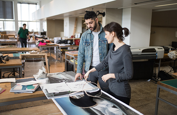 Two students standing reviewing an architecture project in a studio at the Spitzer School of Architecture.