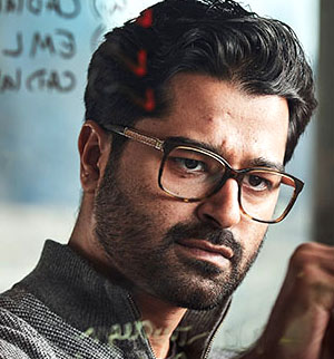 Headshot of Muhammad Ahmad, head slightly tilted to the right, concentrated on writing something.