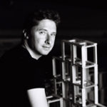 Headshot of David Tajchman, smiling at the camera.