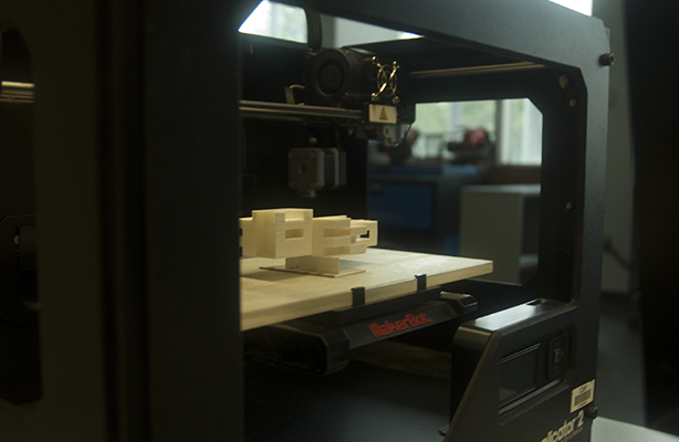 An interior view of the Digital Fabrication Shop at the high-quality Spitzer School of Architecture, featuring a MakerBot 3D printer.