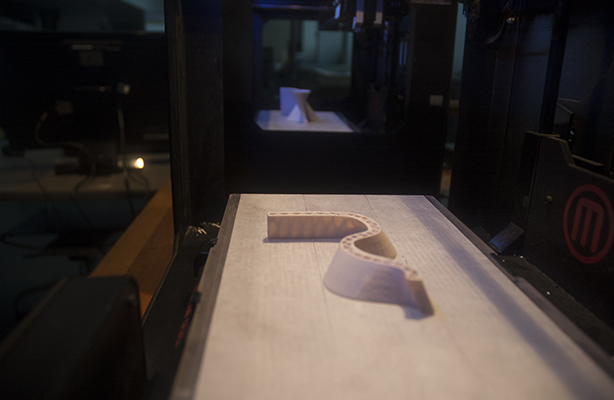 An interior view of the Digital Fabrication Shop at the cutting-edge Spitzer School of Architecture, featuring two CNC machines.