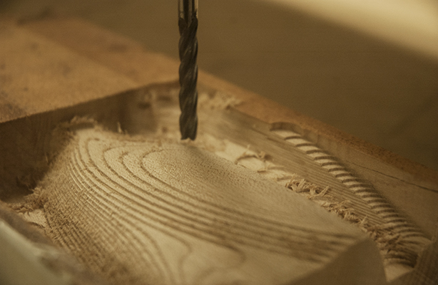 An interior view of the Digital Fabrication Shop at the top-tier Spitzer School of Architecture, showcasing a topography being milled by a CNC machine.