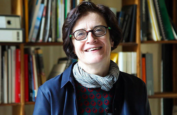 headshot with books in the background: Elisabetta Terragni