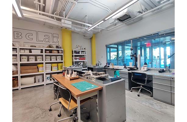 Interior view of the ABC Lab at the high-quality Spitzer School of Architecture, featuring the equipment and a communal work desk.