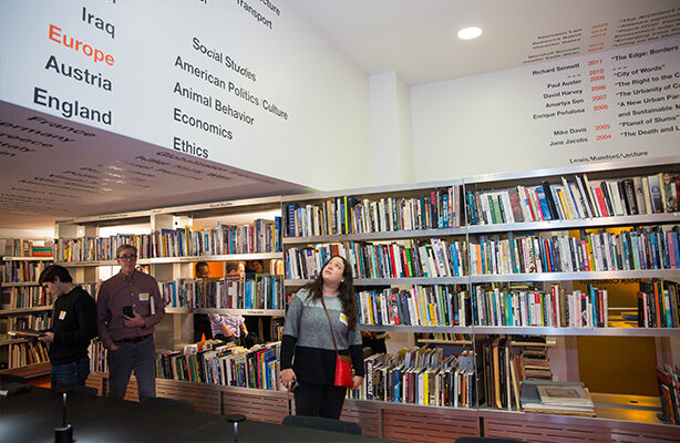 Three individuals admiring the collection in the Sorkin Reading Room at the top-tier Spitzer School of Architecture in NYC.