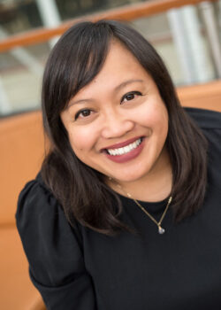 Headshot of Michelle Magalong, dressed in black, smiling at the camera.