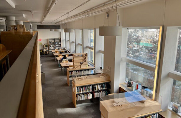 Interior view of the Architecture Library at the budget-friendly Spitzer School of Architecture, captured from the second floor, looking down at the lower level of the library.