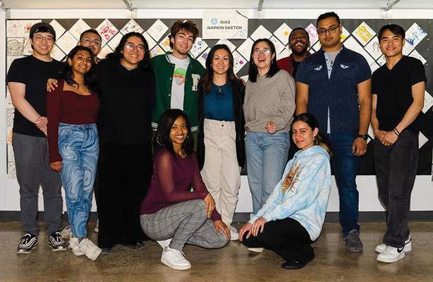 Twelve B. Arch students standing in front of the AIAS 2023 Napkin Sketch at the Spitzer School of Architecture.