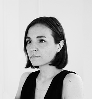 Headshot of Sasha Topolnytska, looking to the left.