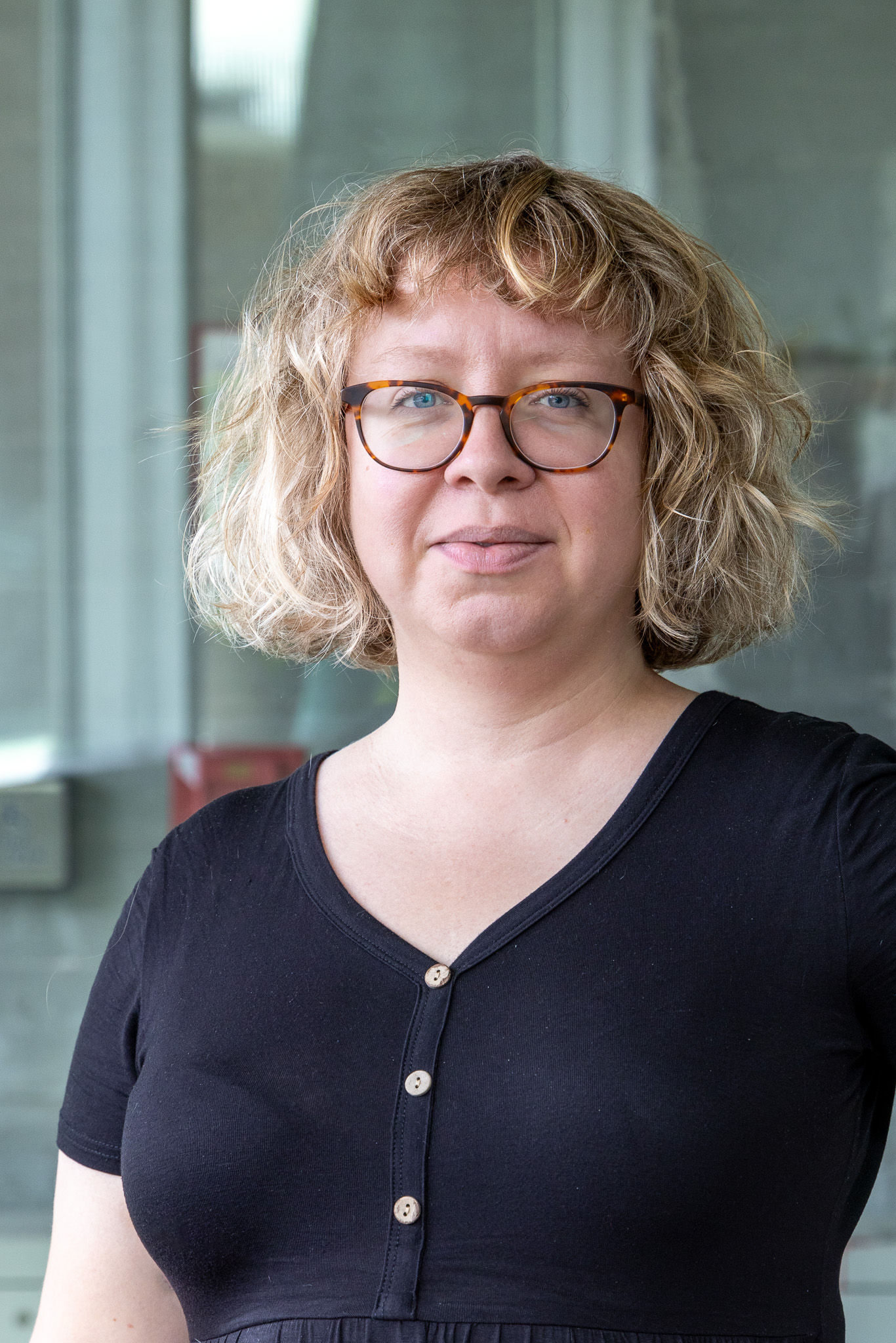 Headshot of Lizzie MacWillie, smiling at the camera.
