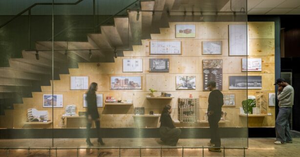 Four B. Arch students admire architectural projects beneath the grand staircase at the premium Spitzer School of Architecture.