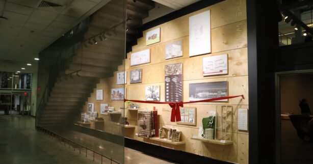 photograph of Under the Stairwell project with red ribbon in foreground.