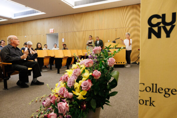 A photo of the Sciame Auditorium during the Spitzer Award Ceremony, with Dean Marta Gutman on the right behind the podium speaking, and guests listening attentively.