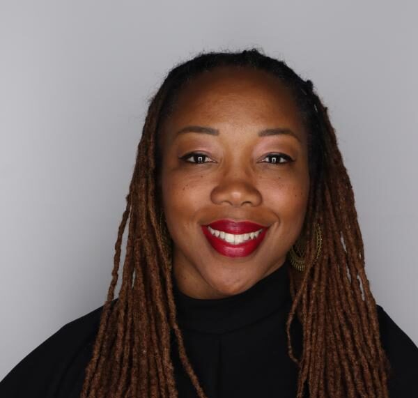 Headshot of Professor Ifeoma Ebo smiling directly into the camera.